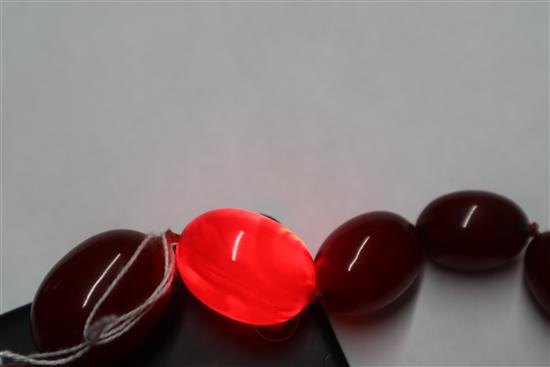 A single strand graduated simulated cherry amber necklace, gross weight, 114 grams, 82cm.